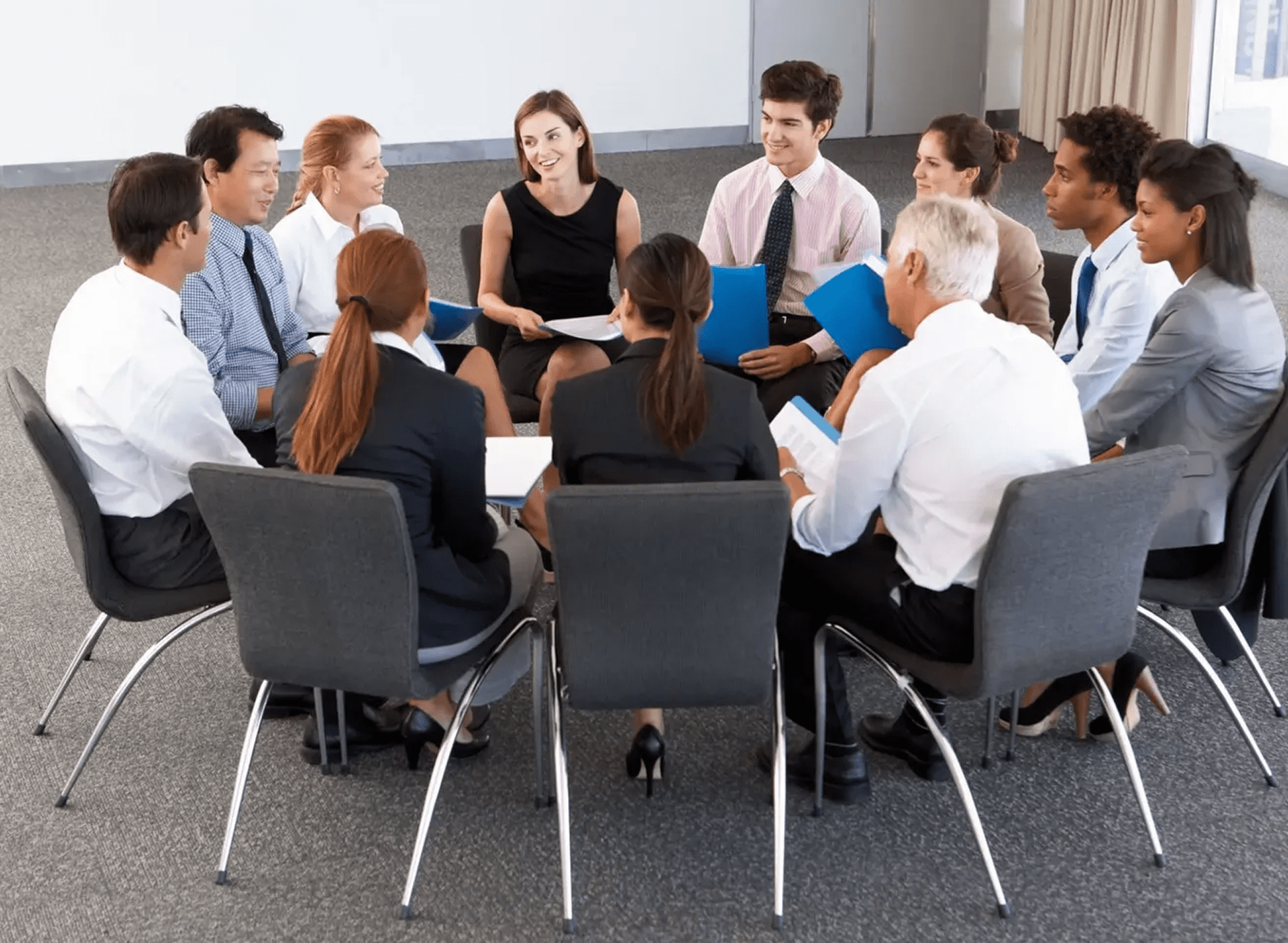 A business team engaged in a meeting around a table.