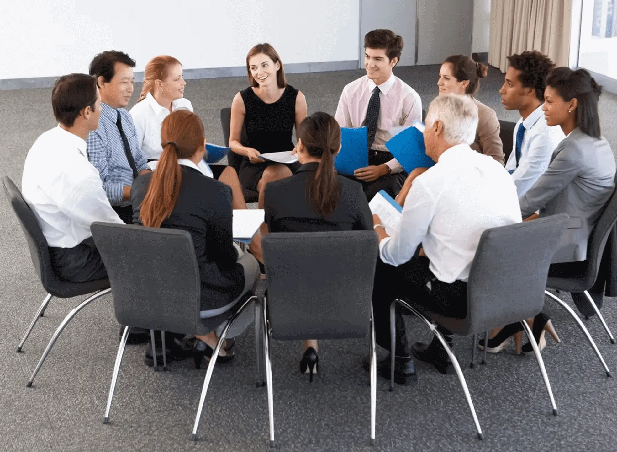 A business team engaged in a meeting around a table.